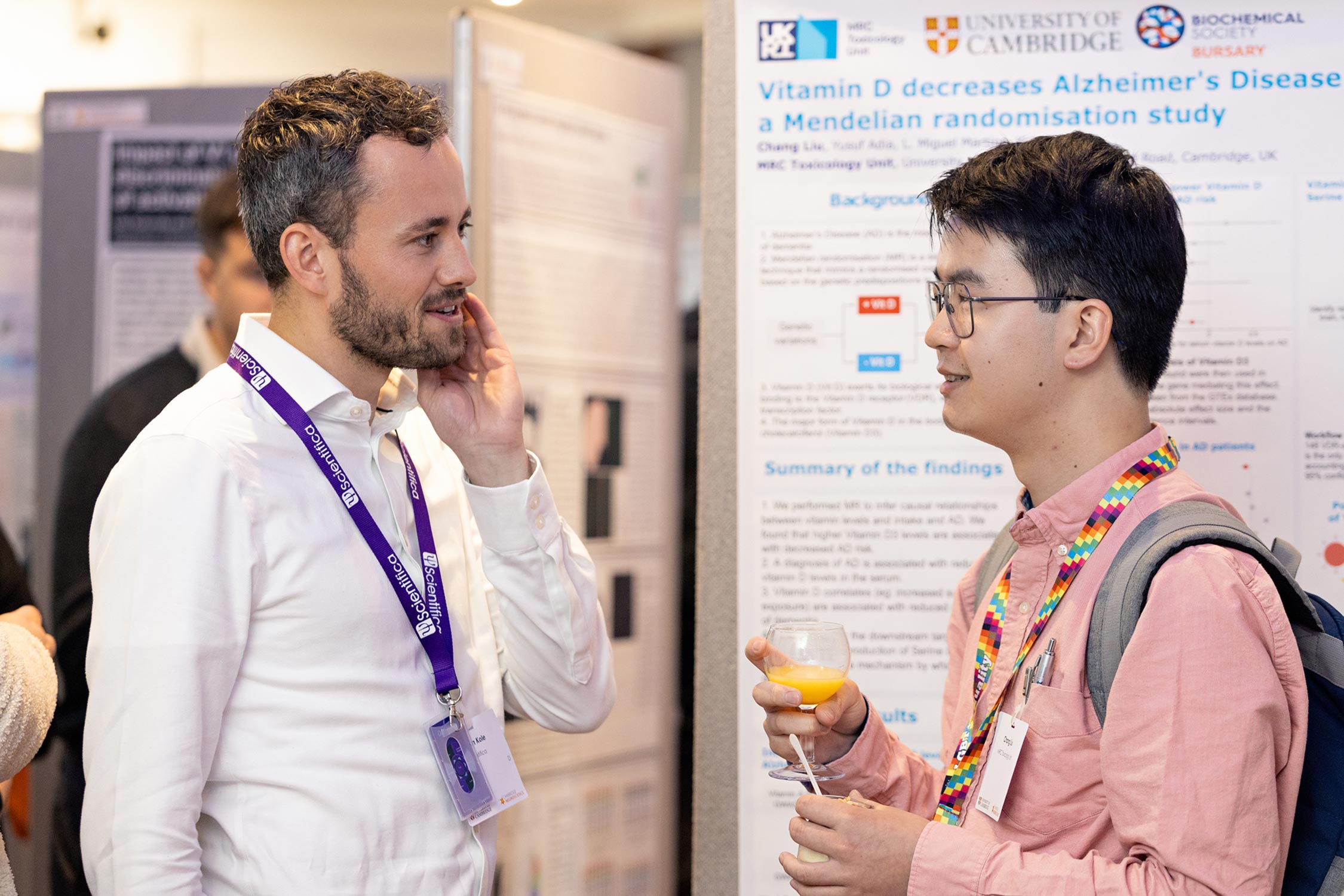Two people talking at a poster session