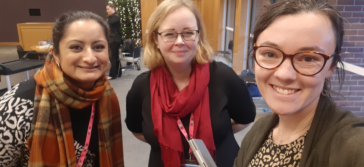 Three women in a conference room