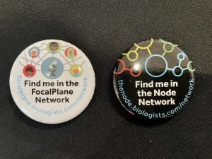 Two pin badges lying on a table