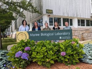 Grace standing outside her host laboratory in Woods Hole.