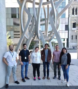 A group of six people standing in front of a research institute. 