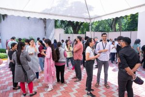 Attendees mingling under a marquee in between sessions at the meeting. 