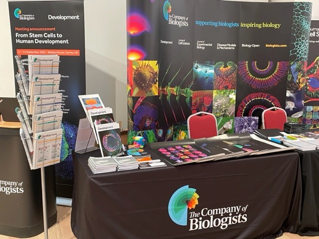 An exhibition booth with The Company of Biologists logo