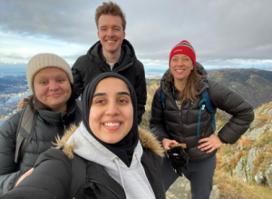 Four people on top of a mountain